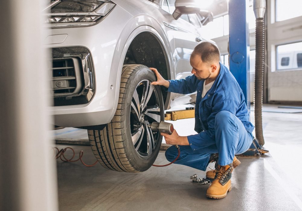 Auto mechanic checking car